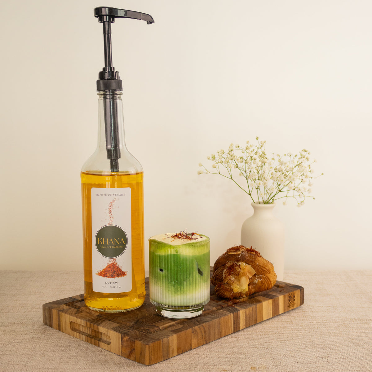 Khana Saffron syrup lifestyle - golden saffron latte with syrup pump