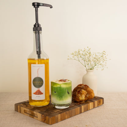 Khana Saffron syrup lifestyle - golden saffron latte with syrup pump